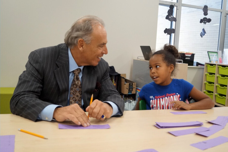 Ken Allen with a happy little girl.